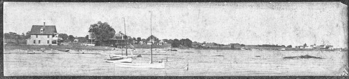 wide scene taken offshore showing houses and small boats enhanced
