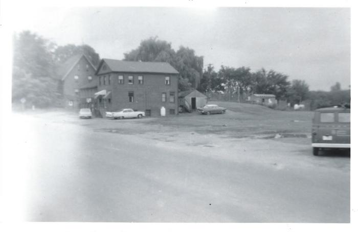 Hall & Muska Gas Station and Barber Shop, Main Street Broad Brook (Photo of where it once stood). Moved February 1, 1967 to the back of the museum.