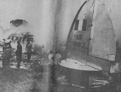 Members of fire companies direct streams of foamite on burning fuselage of ill-fated airliner.