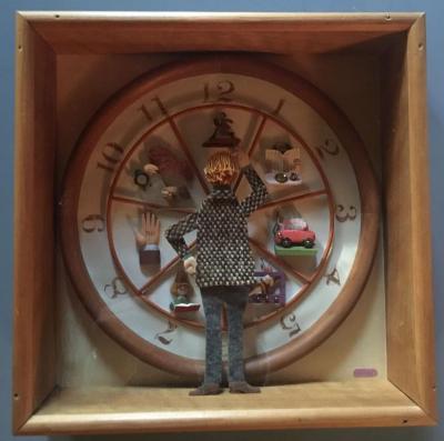 Man in tweed coat facing a clock