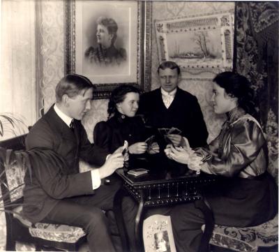 Portrait of Four People Playing Cards