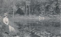 Portrait of Woman Sitting Near a Pond