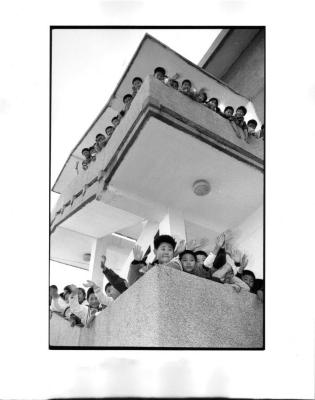 [School children waving from exterior stairwell], Yangzhou, China
