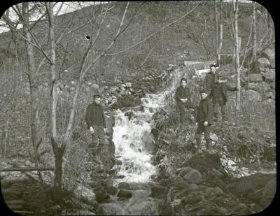 Boys hiking near stream
