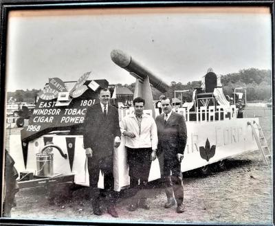 Photo of 3 men next to a parade float