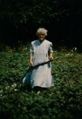 Photograph of Charcoal Annie w/ agricultural tool 