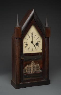Clock: Gothic style mantel clock with a glass panel featuring Barnum's Iranistan home