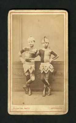 Photograph: Portrait of two boys in acrobat costumes with hats