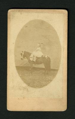 Photograph: Portrait of a young girl on a pony