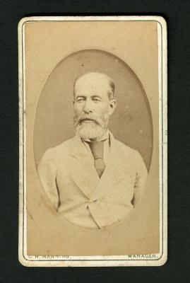 Photograph: Portrait bust of bearded man in light jacket