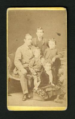 Photograph: Portrait of father and four children in street clothes