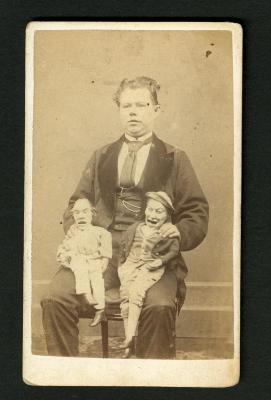 Photograph: Portrait of man with two puppets