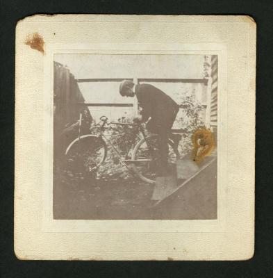 Photograph: Man leaning over bicycle