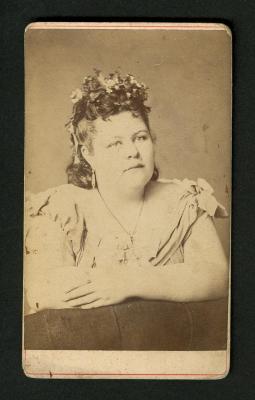 Photograph: Portrait of full figured woman with flowers in hair
