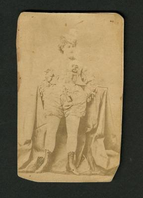 Photograph: Portrait of female performer in costume with hat, shorts and boots