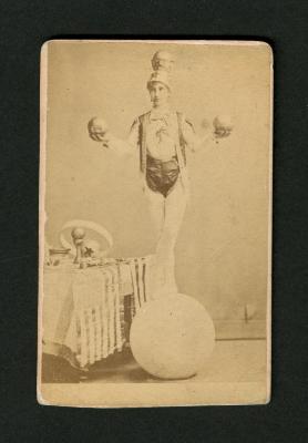 Photograph: Portrait of female acrobat standing on a large ball