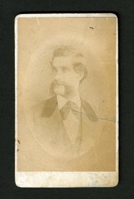 Photograph: Portrait bust of man with mutton-chop mustache, large bow tie