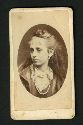 Photograph: Portrait bust of woman with long hair, beaded necklace