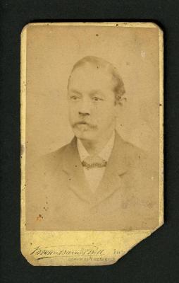 Photograph: Portrait bust of man with mustache and dotted tie