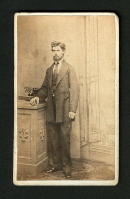 Photograph: Portrait of man standing, with book, top hat and gloves 