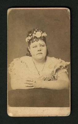 Photograph: Portrait of full figured woman with flowers in hair