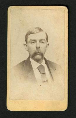 Photograph: Portrait bust of man with full mustache and necktie