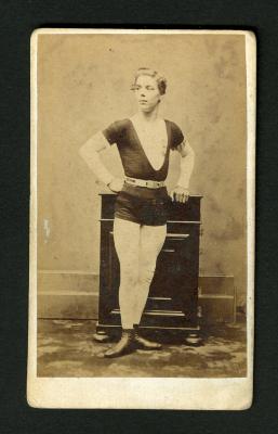 Photograph: Portrait of male acrobat in dark costume