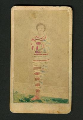 Photograph: Portrait of standing man in striped costume