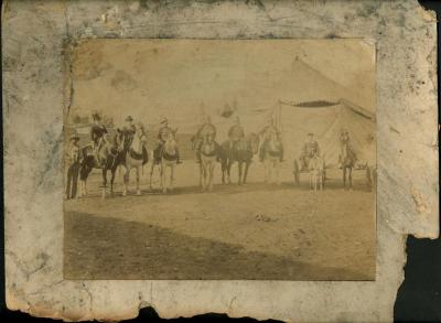 Photograph: Group of equestrian performers posed outside circus tent