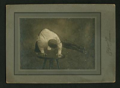 Photograph: Eddie F. Smith performing pike-position handstand