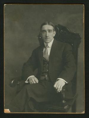Photograph: Portrait of Eddie F. Smith seated in carved chair