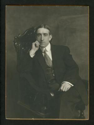 Photograph: Portrait of Eddie F. Smith seated in carved chair, with raised hand resting on his cheek