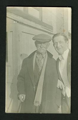 Postcard: Older man in street clothes, younger man in white tie and tails