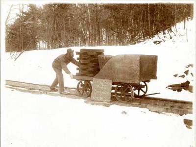Publicity photo showing a cart load of pressed black powder cakes
