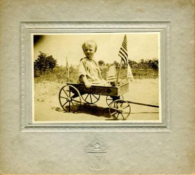 Child in Wagon with Flags