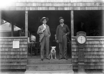 Two men standing on covered porch
