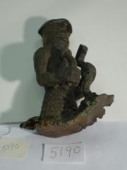 Squatting Male Figure holding nail and hammer