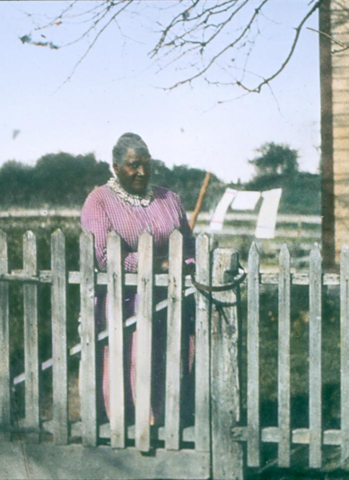 Woman by Fence
